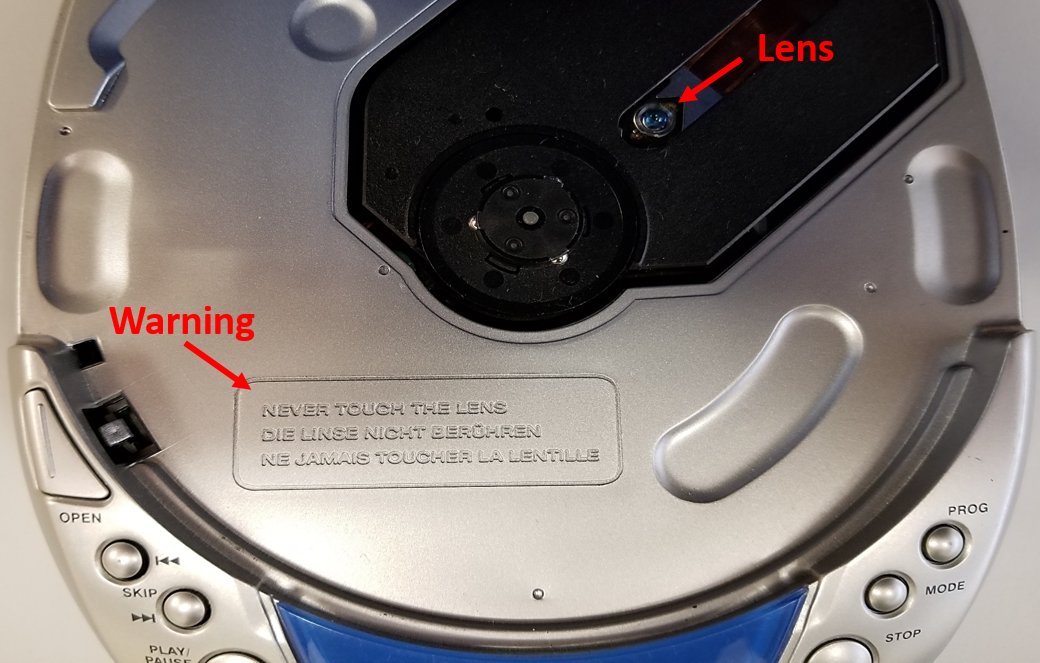 Portable CD player with the cover open. The lens is clearly visible and there is a warning to never touch the lens.